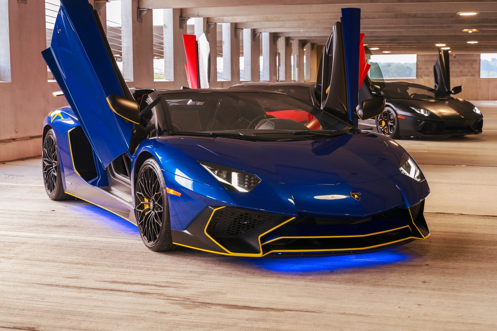 Blue Lamborghini with scissor doors raised
